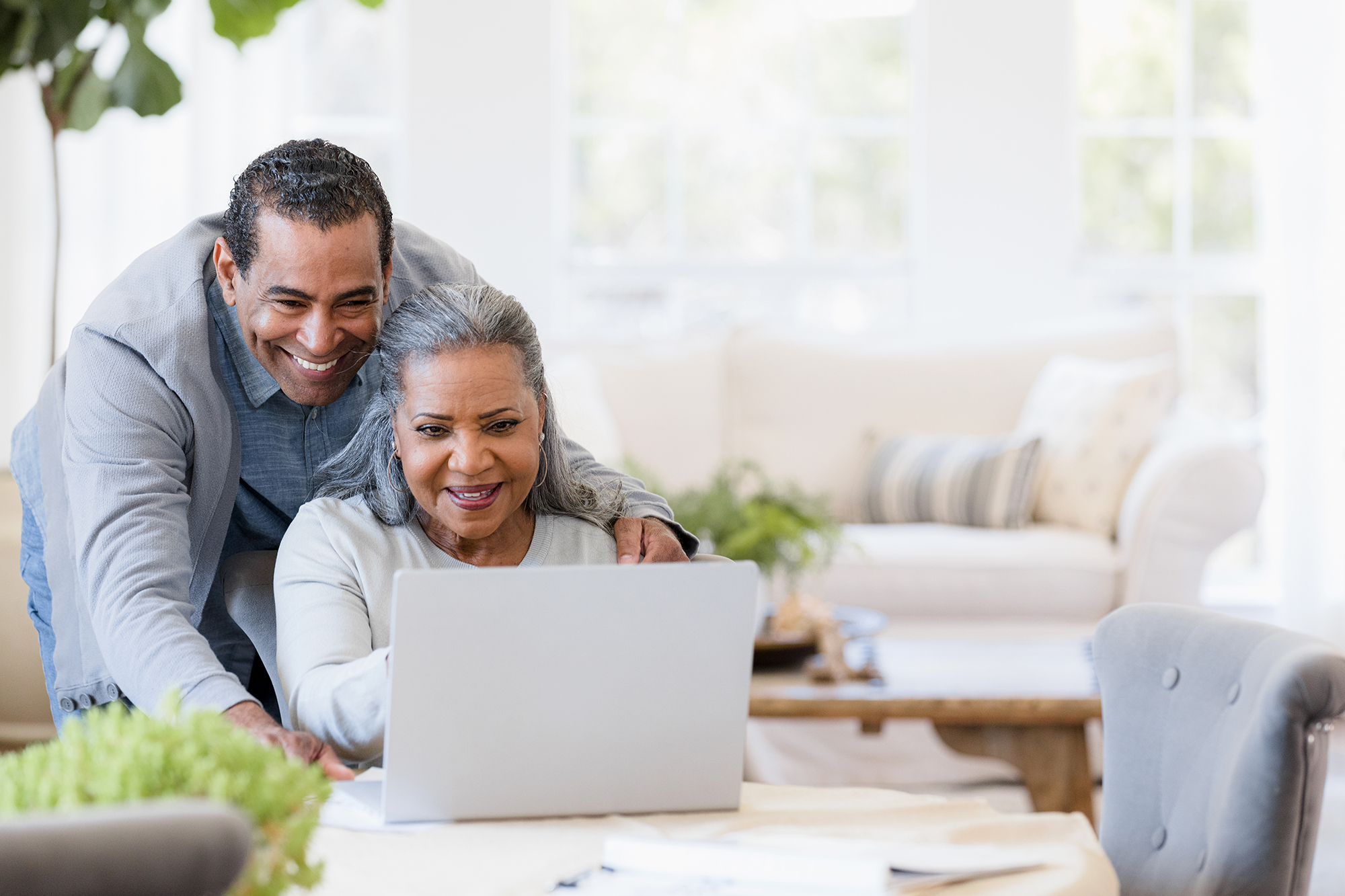 Couple looking at a laptop.